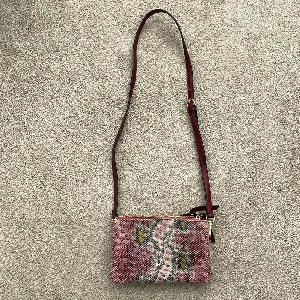 Purple snakeskin patterned purse with rhinestones on the front
